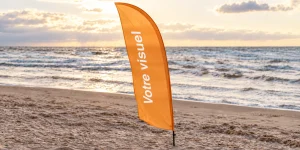 Illustration d’un beachflag orange personnalisable installé sur une plage